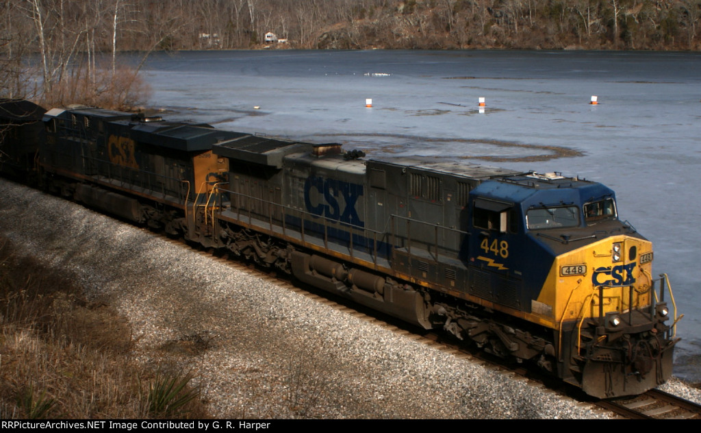 716 - CSXT 448 passing melting pond ice.  Small flock of sea gulls is resting on the ice in the distance.